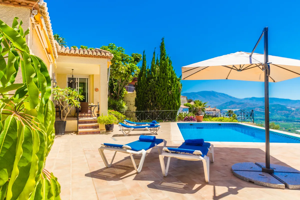 Sonnenliegen und Sonnenschirm mit Blick auf die Costa Tropical